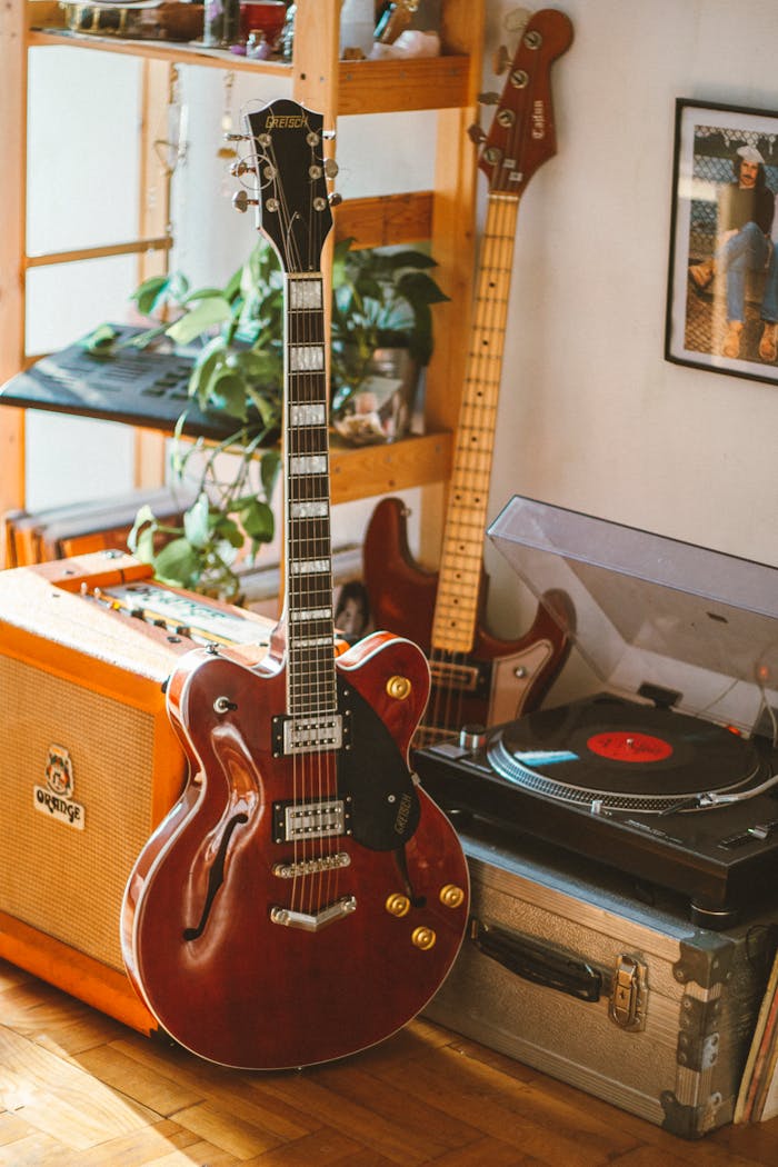 Cozy music corner with a vintage electric guitar, amplifier, and vinyl turntable.