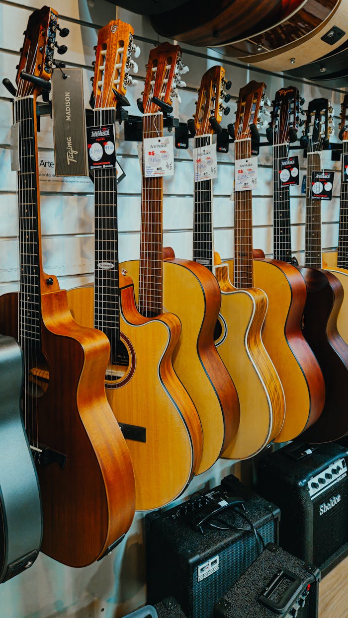 A row of beautifully crafted acoustic guitars on display in a music store, highlighting variety and craftsmanship.