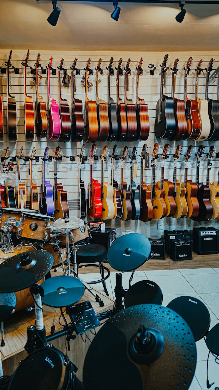 Vibrant display of guitars and drums in a music store, showcasing a variety of instruments.